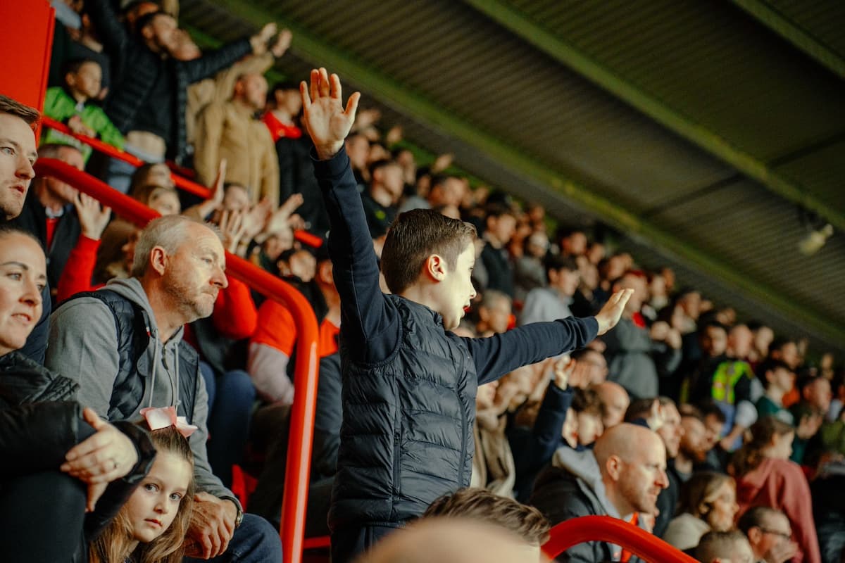 A young Charlton Athletic fan cheering in the stands