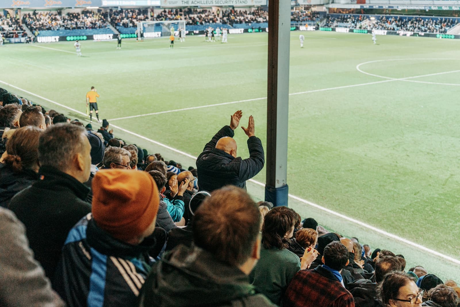 A QPR fan standing on his own clapping